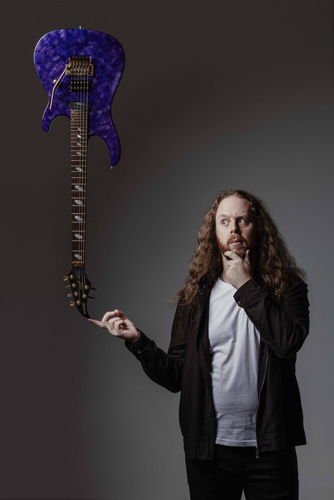 Karl Szulik of 1THIRTY8 with a purple guitar