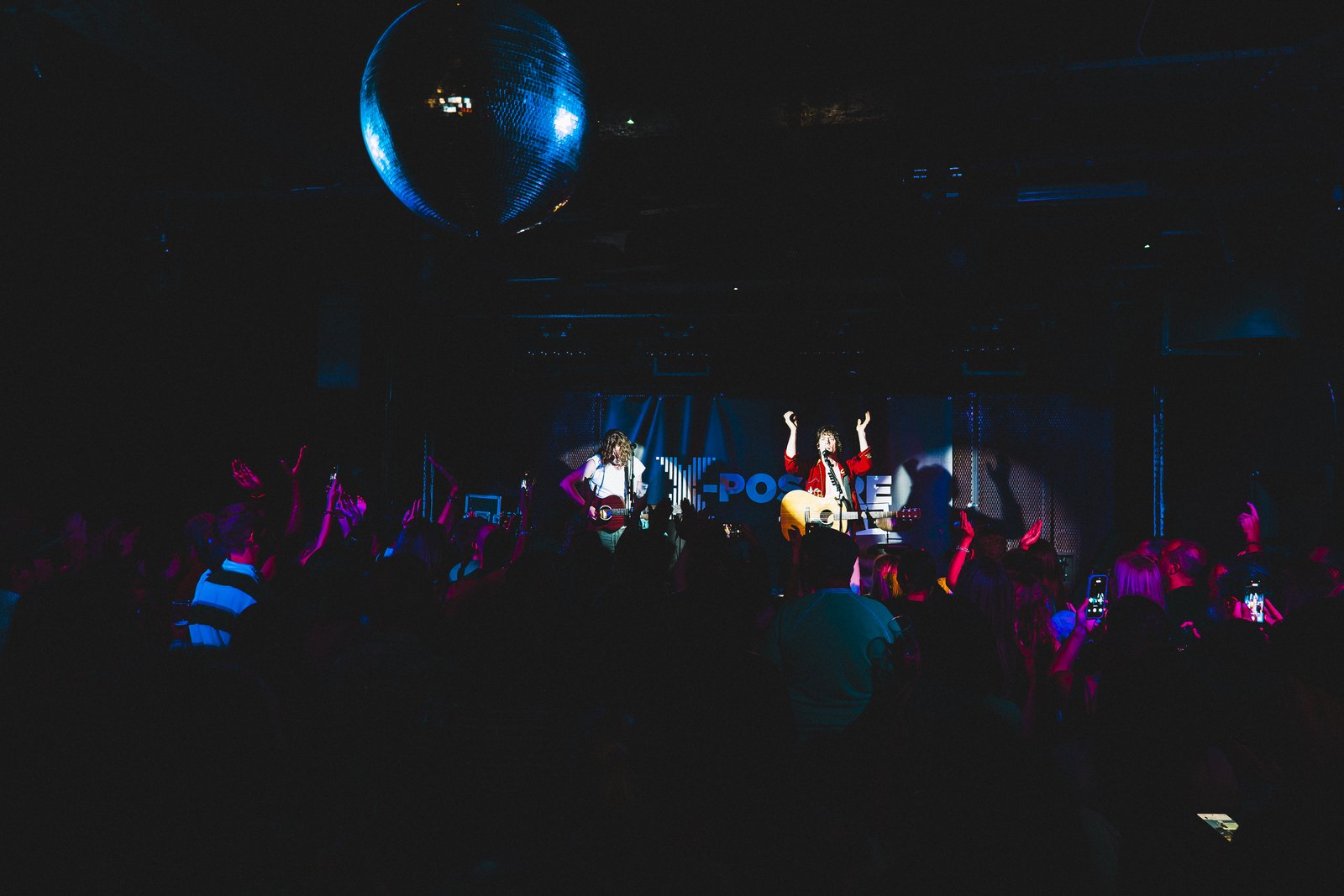 Razorlight on stage at the Barfly with a packed crowd under a glitter ball